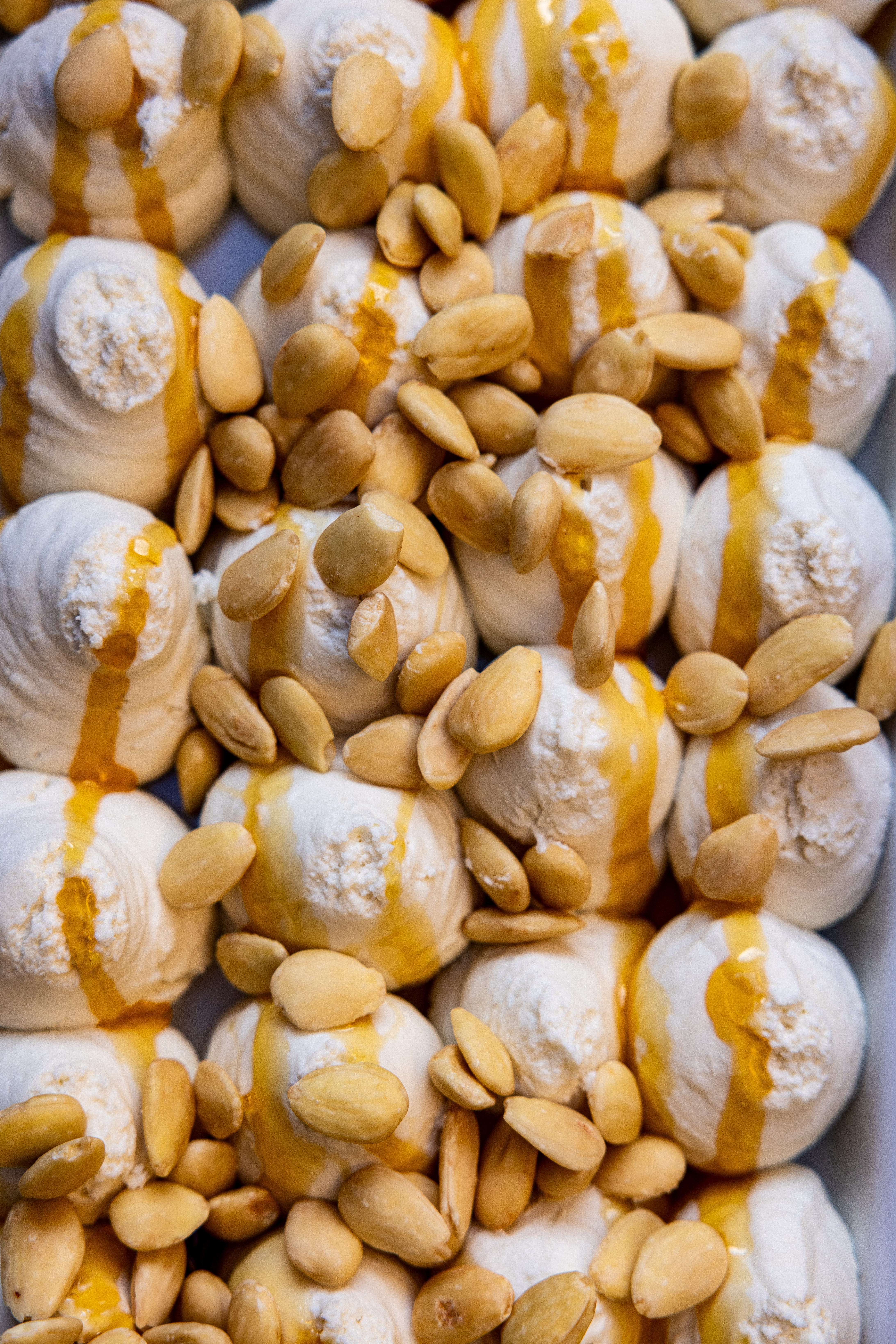 Vanilla ice cream with Almonds and Honey – Roscioli NYC Fresh vanilla ice cream topped with toasted almonds and honey drizzle, prepared by Roscioli NYC.